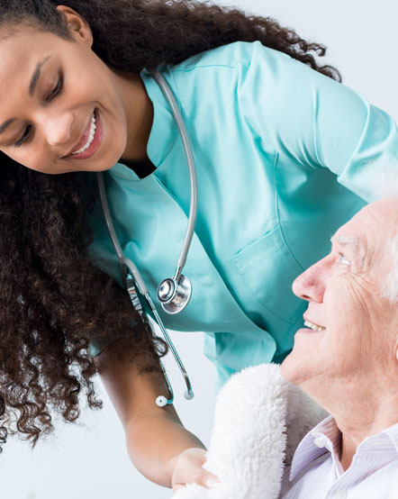 Elderly Man Looking at the Nurse and Smiling